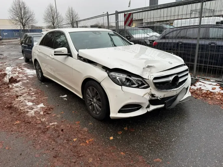 mercedes e220 front completely damaged. white limousine.