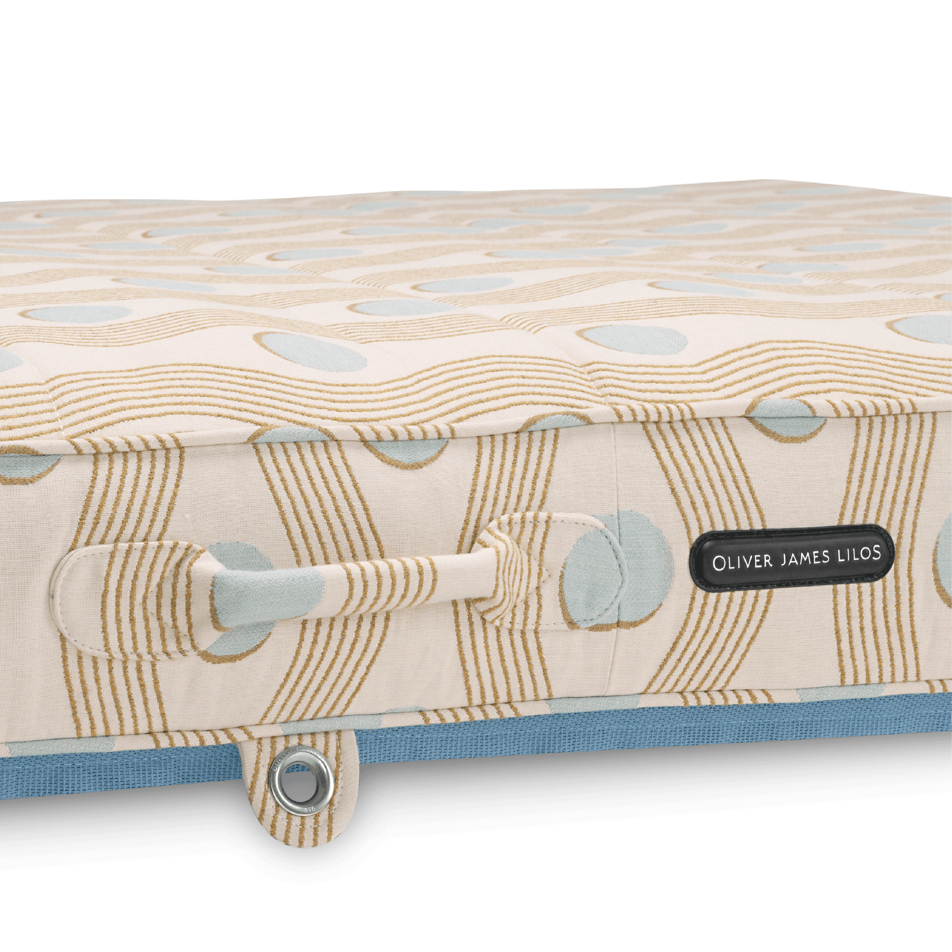 Close-up of pool float showing cream geometric-weave handle, block-print-inspired pattern, and stainless eyelet