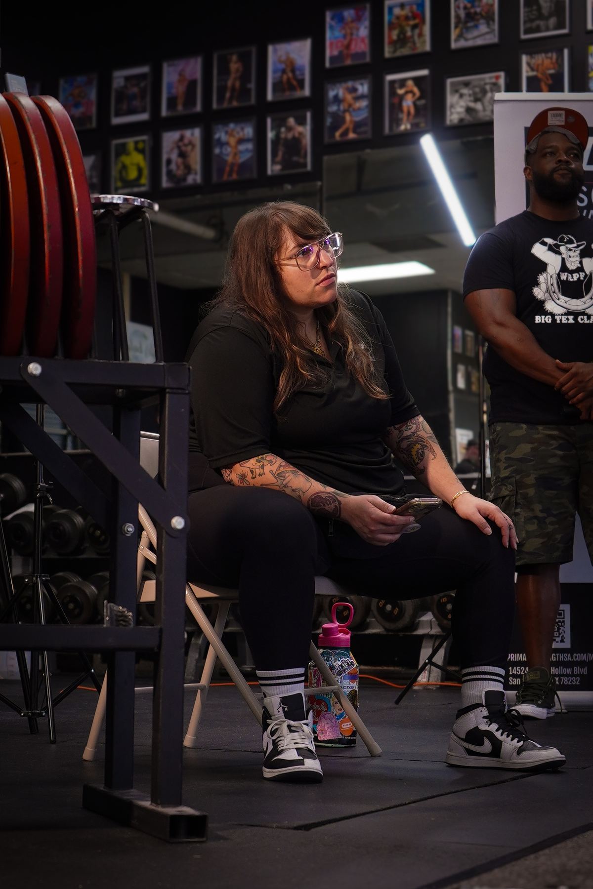 Powerlifting coach reviewing technique with an athlete during competition prep