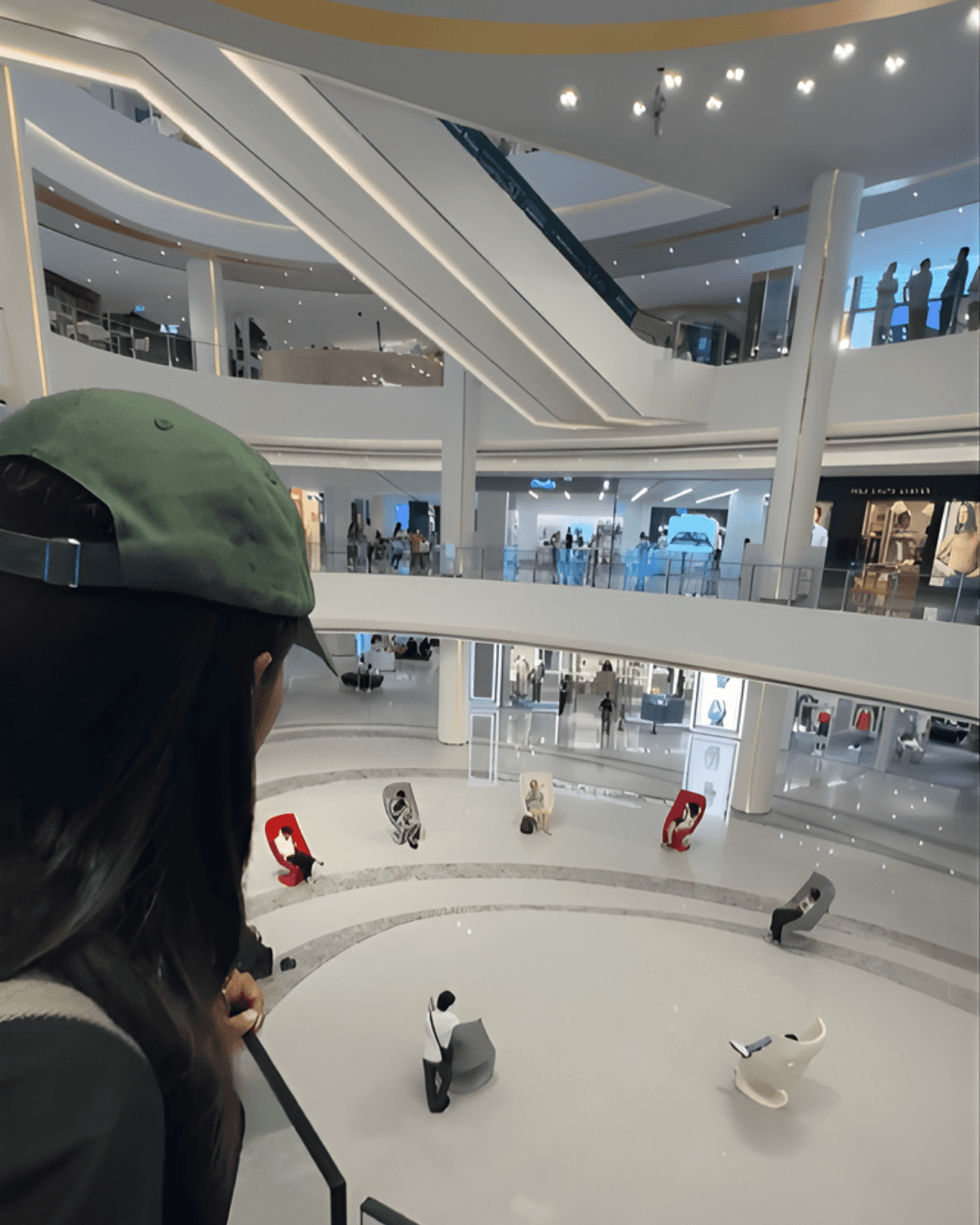 A wide-angle photo of an empty mall atrium serves as the real-world base for the digital elements