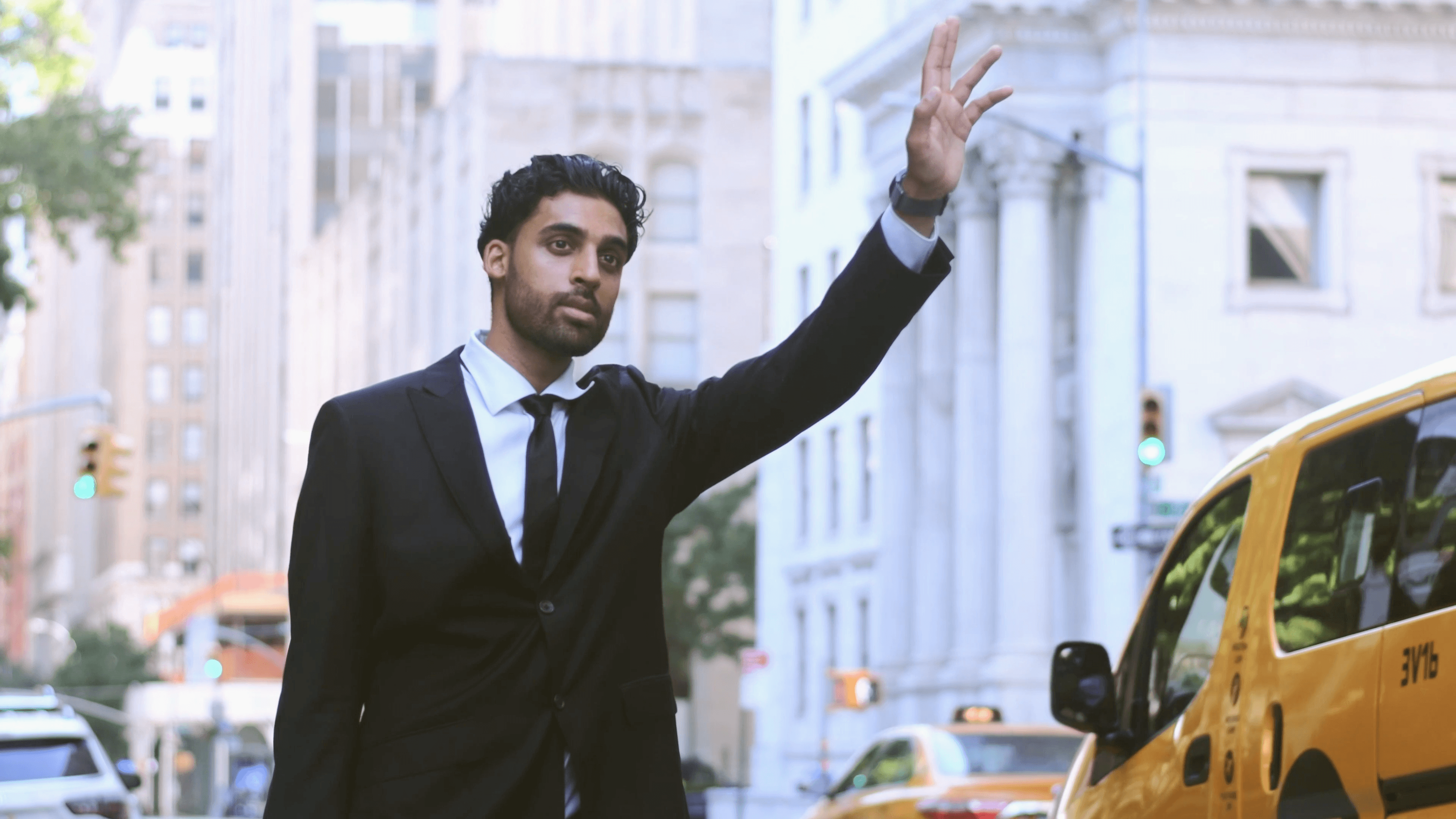 A man who is trying to grab a taxi