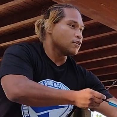 a man with a goatee smiles at the camera
