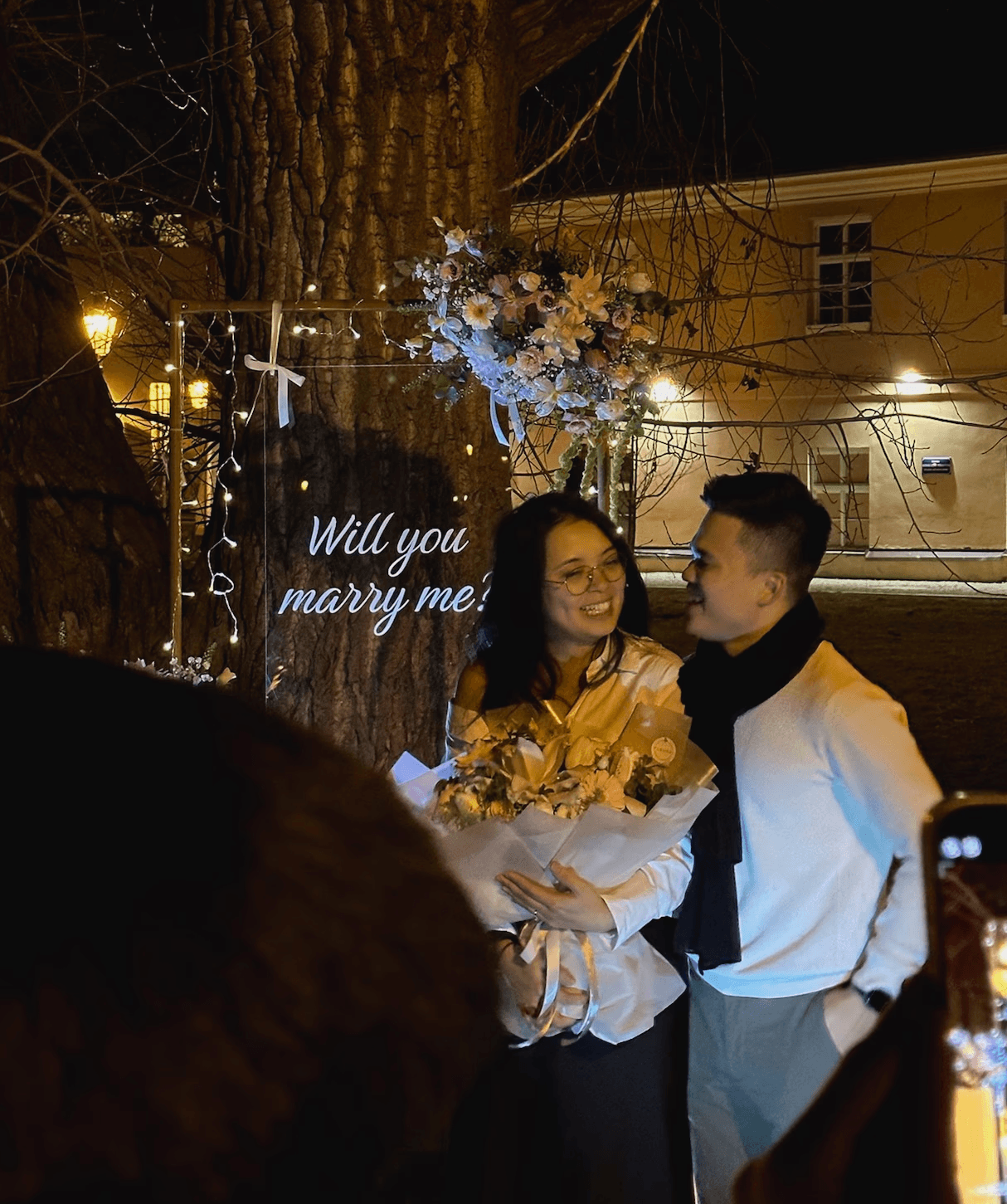 Two gold wedding rings rest atop a soft, textured fabric with a subtle pattern. The rings shine under gentle light, evoking themes of love and commitment.