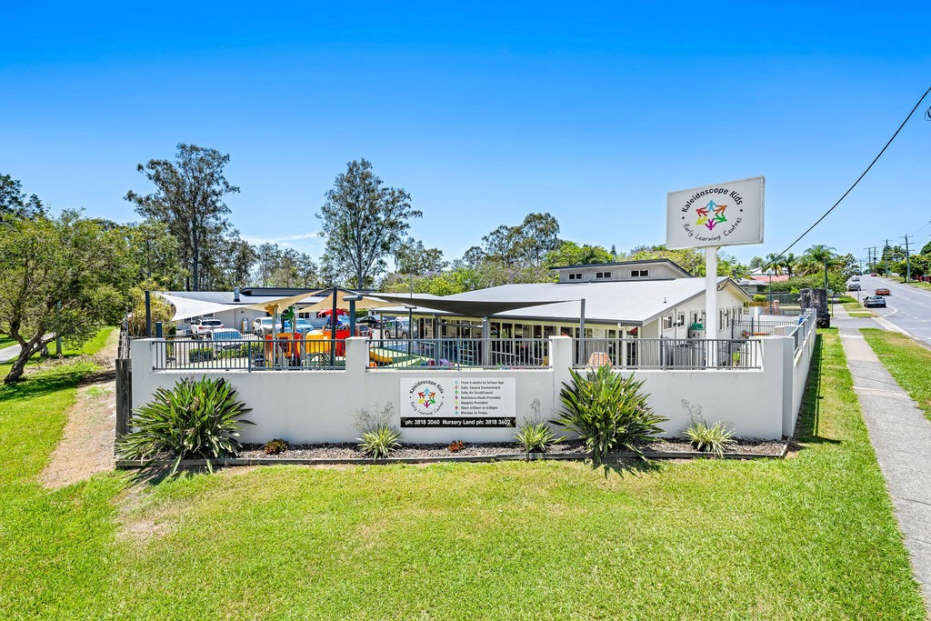 Aerial view of Kaleidoscope Kids Goodna childcare centre, spacious campus with playgrounds and parking in Goodna QLD.