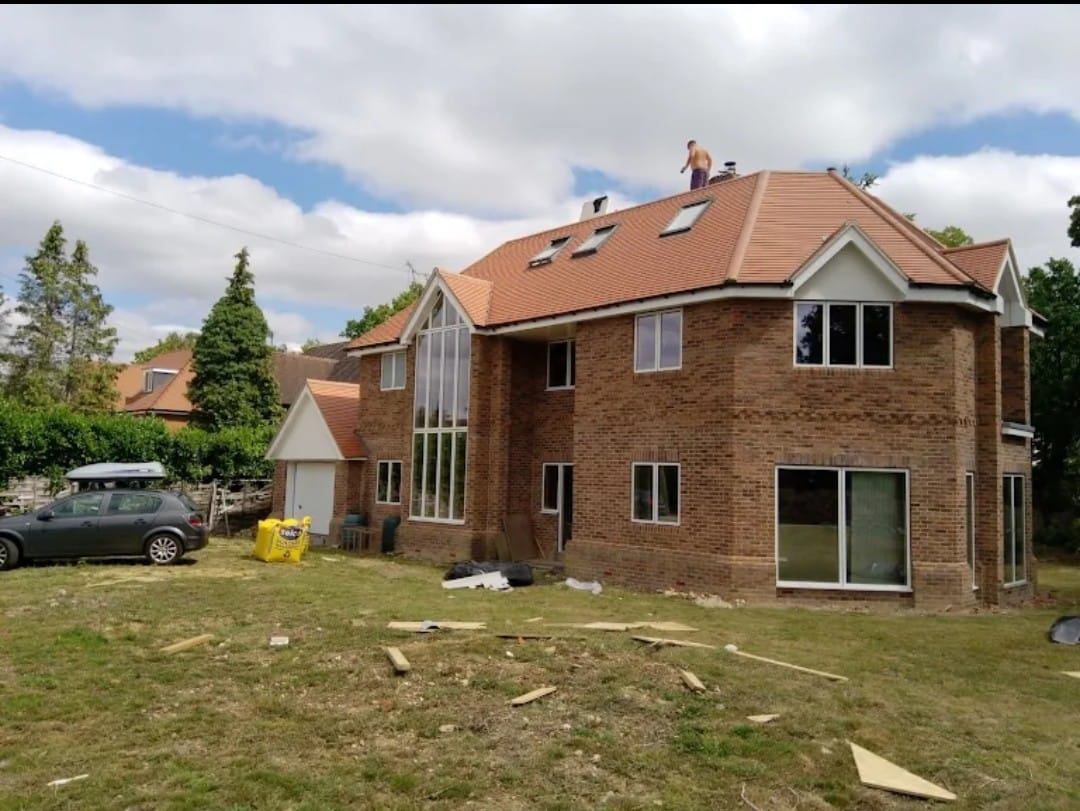 a large brick house with two garage doors