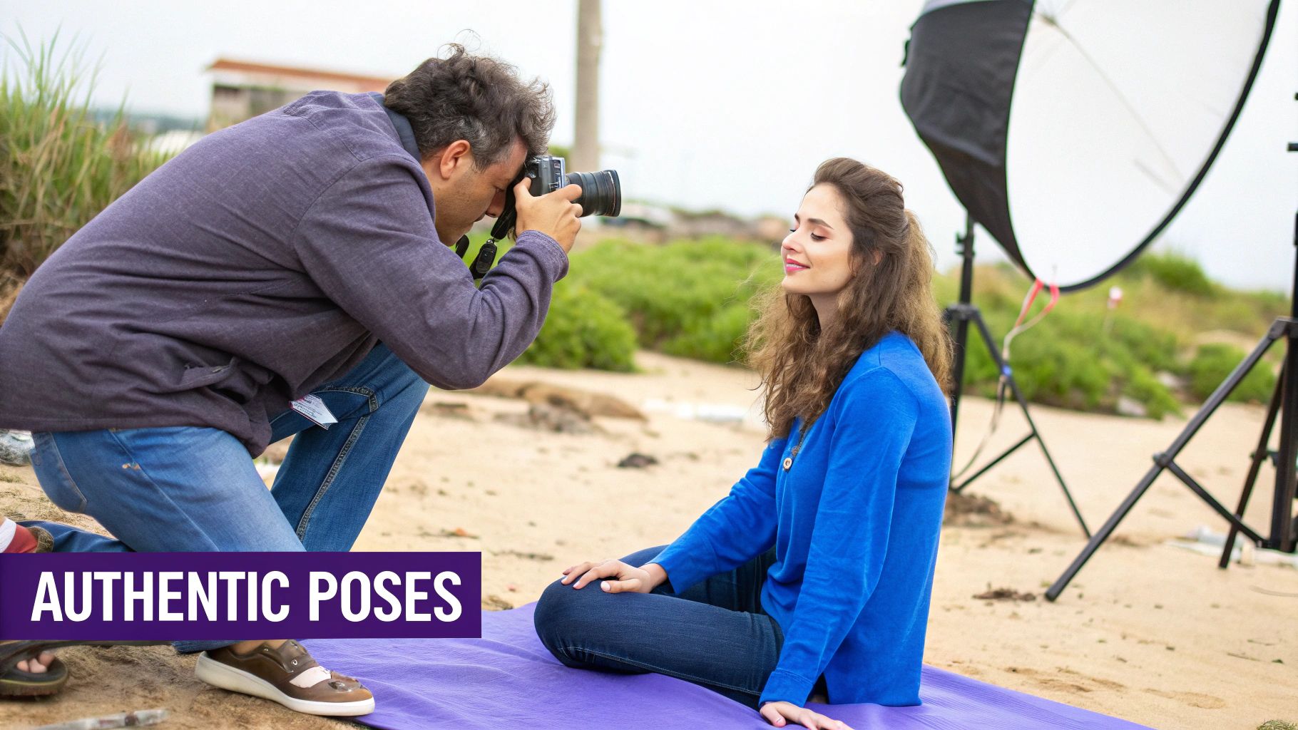 A male photographer kneels on a sandy beach, capturing a relaxed female model sitting on a purple mat.