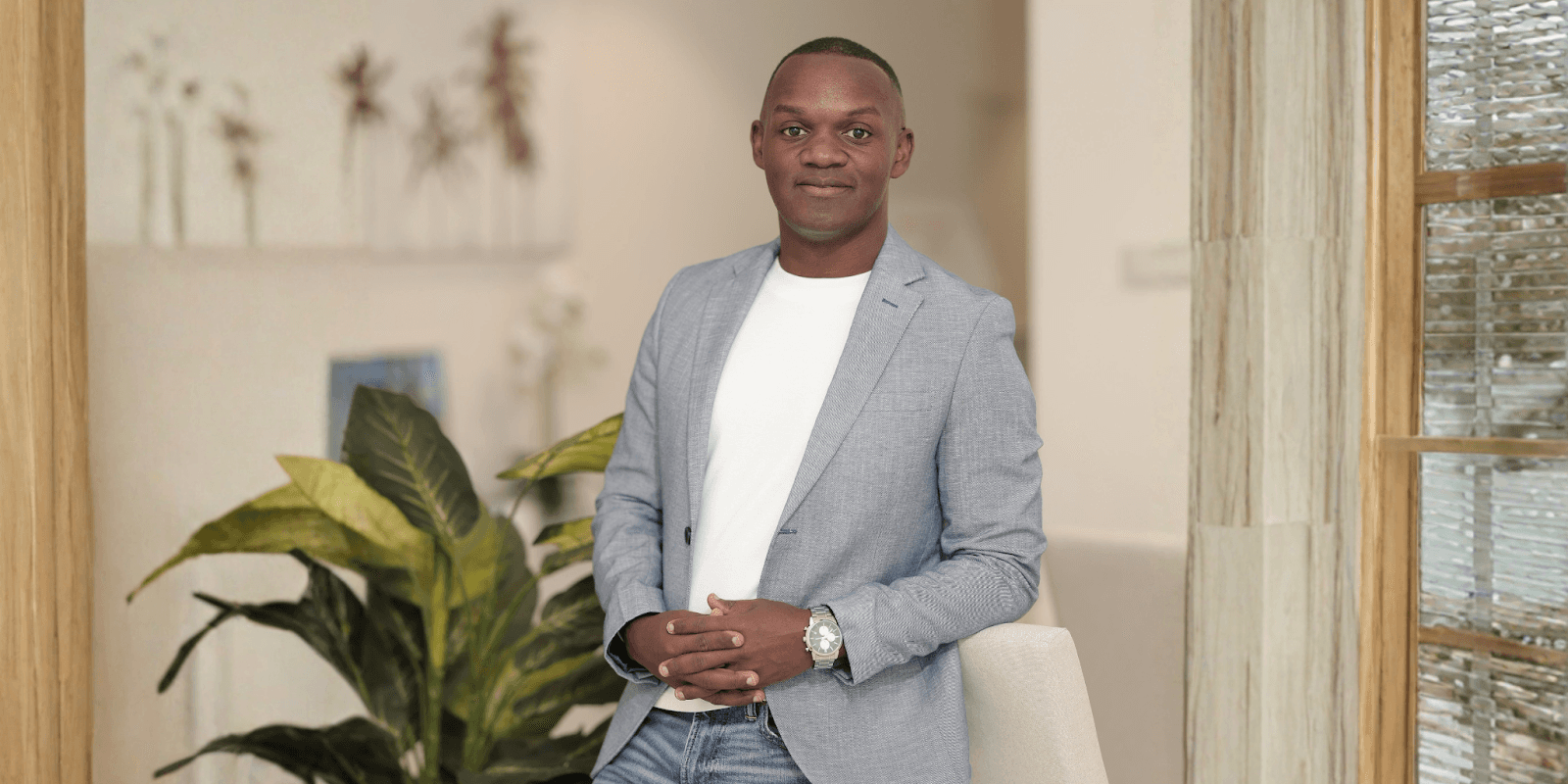 Kim Kiyingi, career coach and founder of Inspire Ambitions, standing confidently in a professional setting, promoting personal growth.