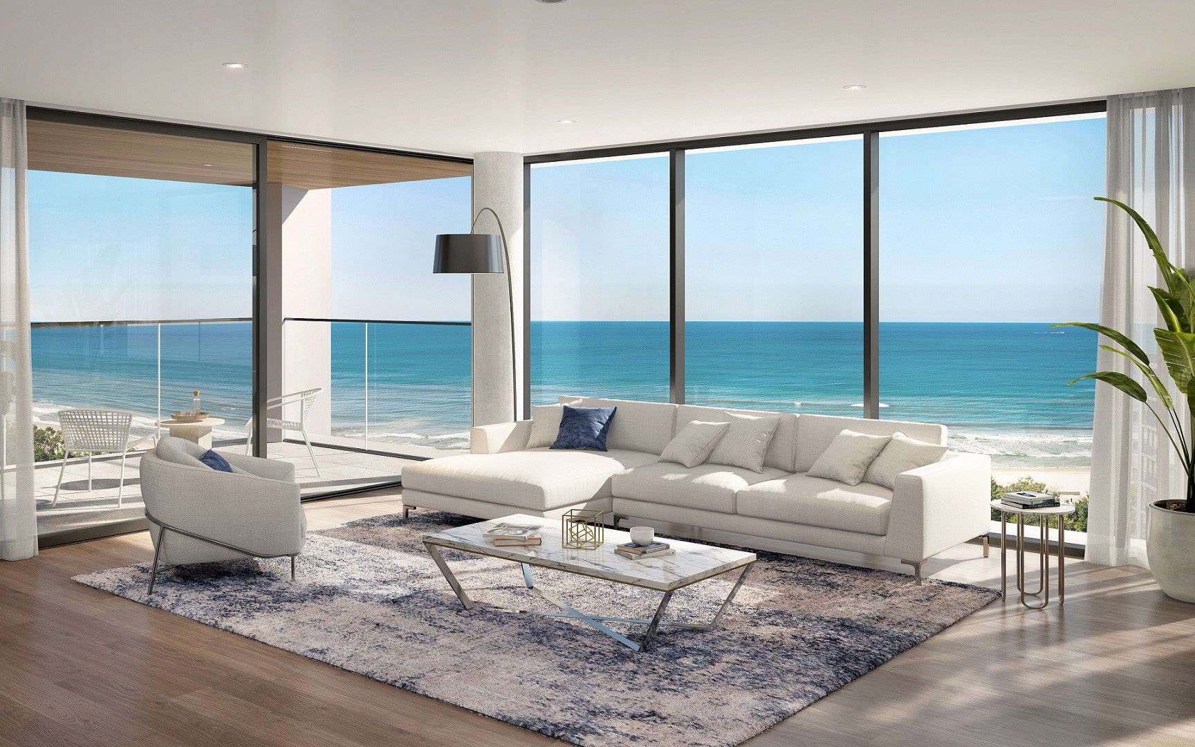Three-Bedroom Lounge East View: Elegant open-plan living room at The Sterling showcasing panoramic ocean views, contemporary décor and large balcony spaces perfect for coastal living.