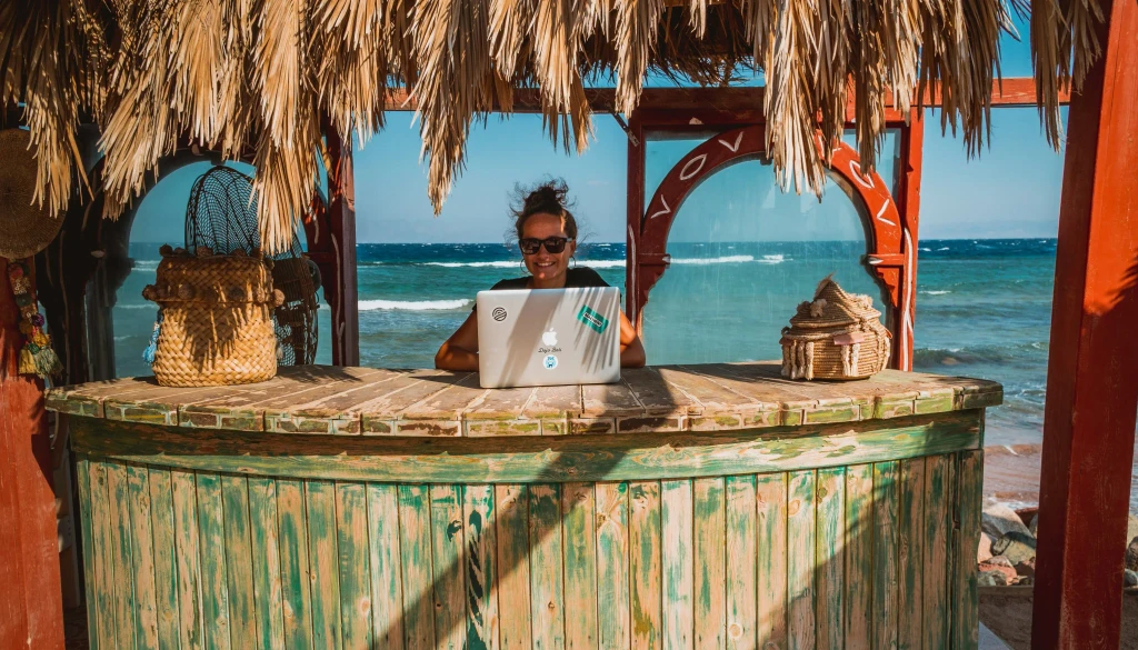 Girl working from beach