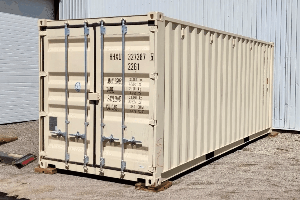 20' New (1 trip) Beige container on wood blocks