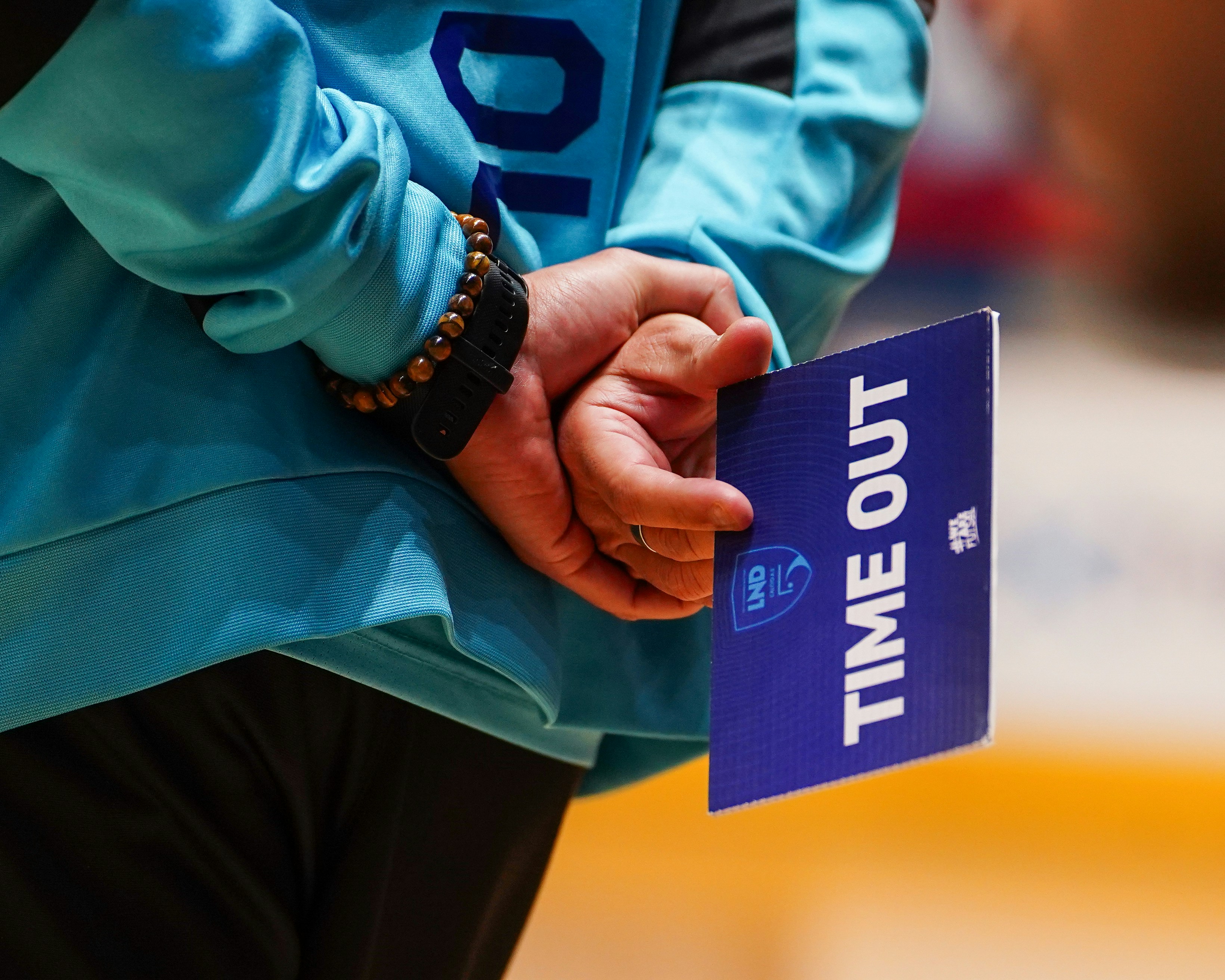 Person holding a blue time out sign