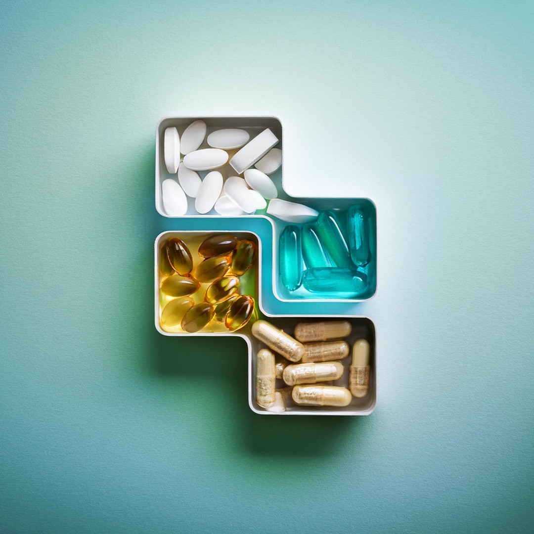 gold and black bottle on white wooden table