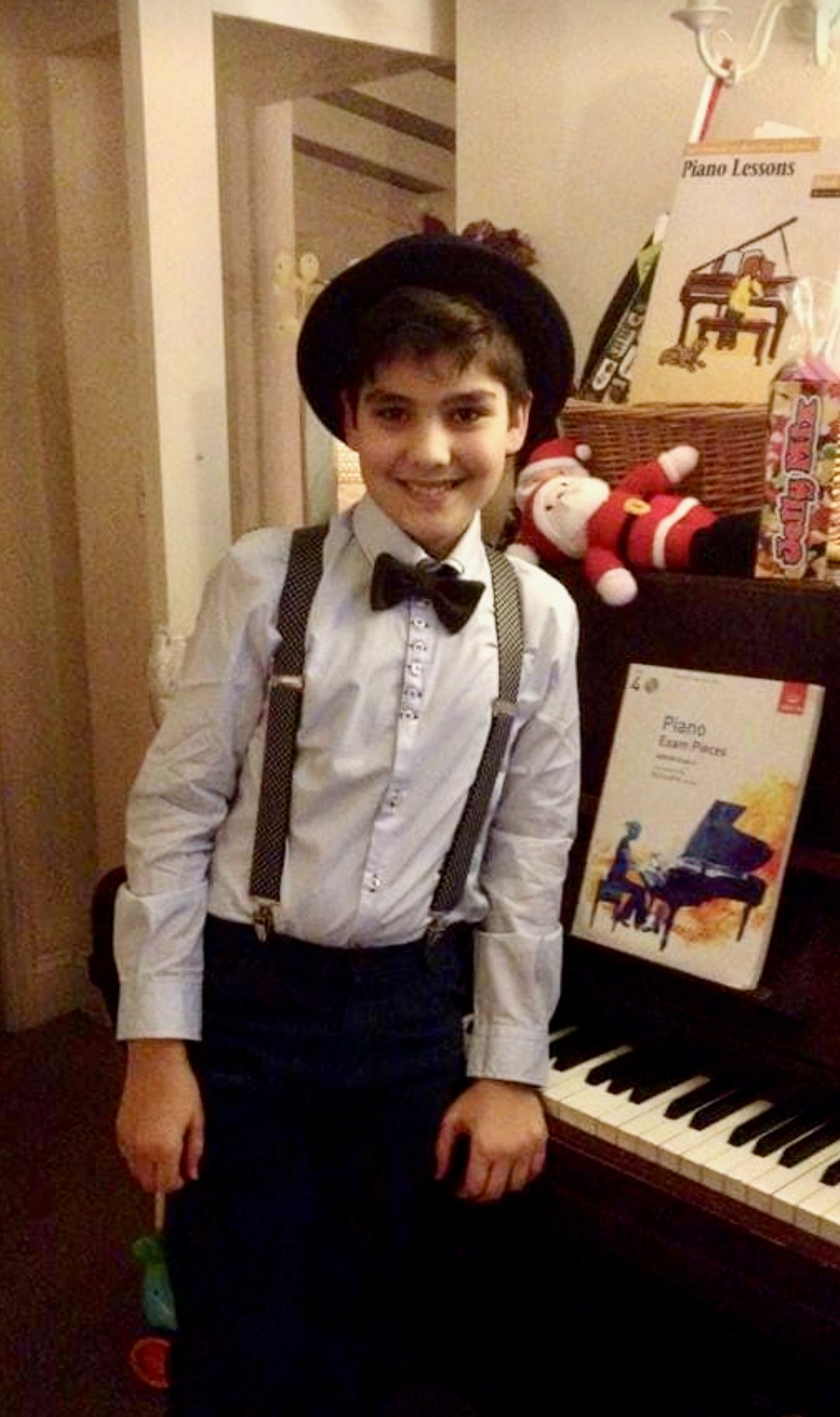 Isaiah beside the piano as a child