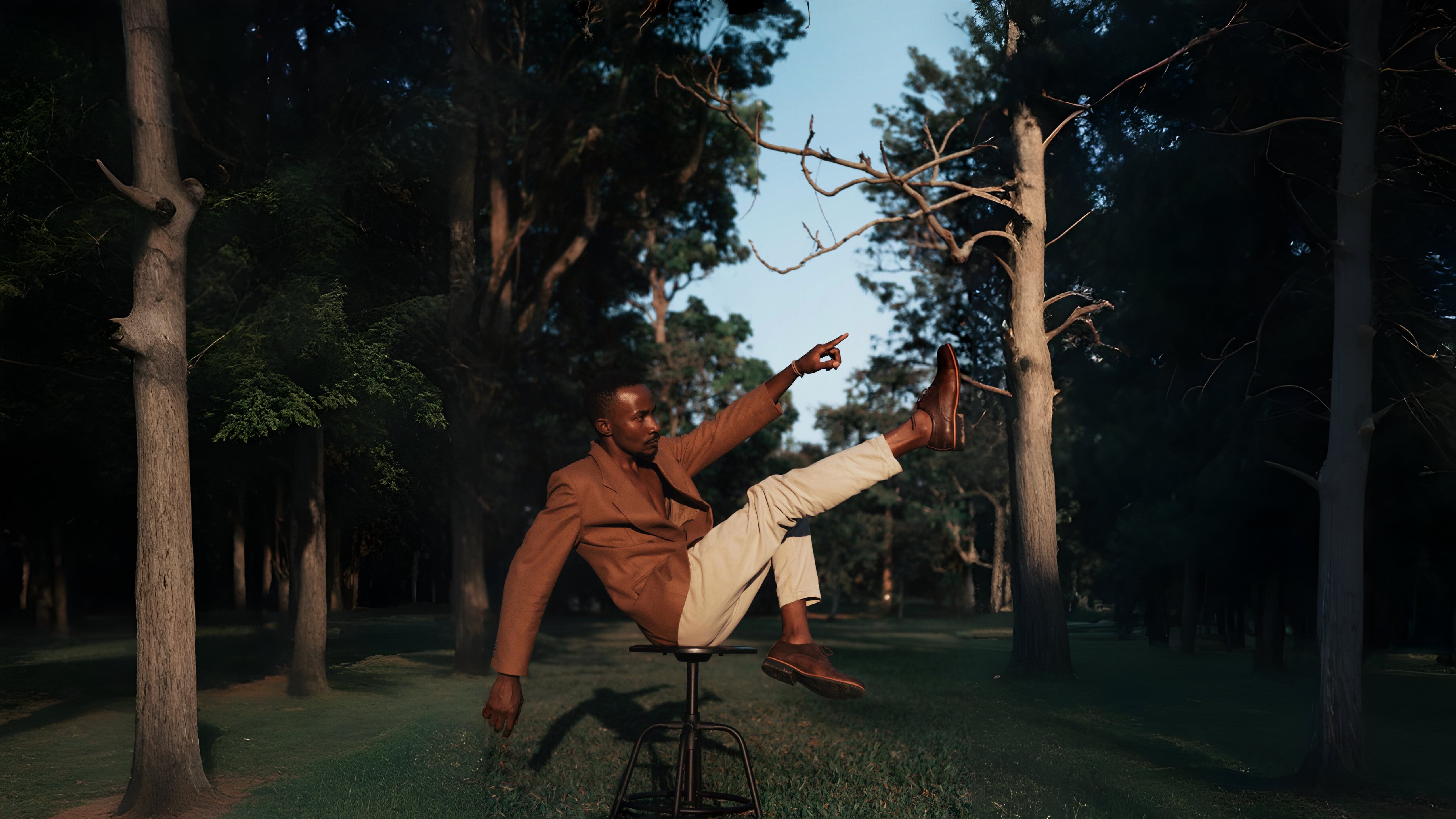 Man sitting posing on a barstool.