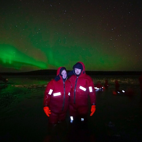 Ice Floating in Forest Lake with Aurora Borealis