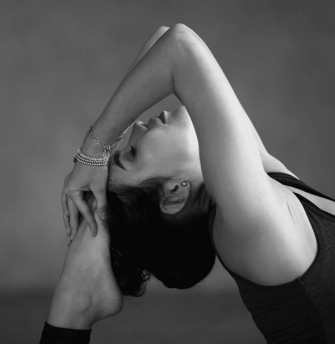 Athletic woman improving flexibility through zen stretch