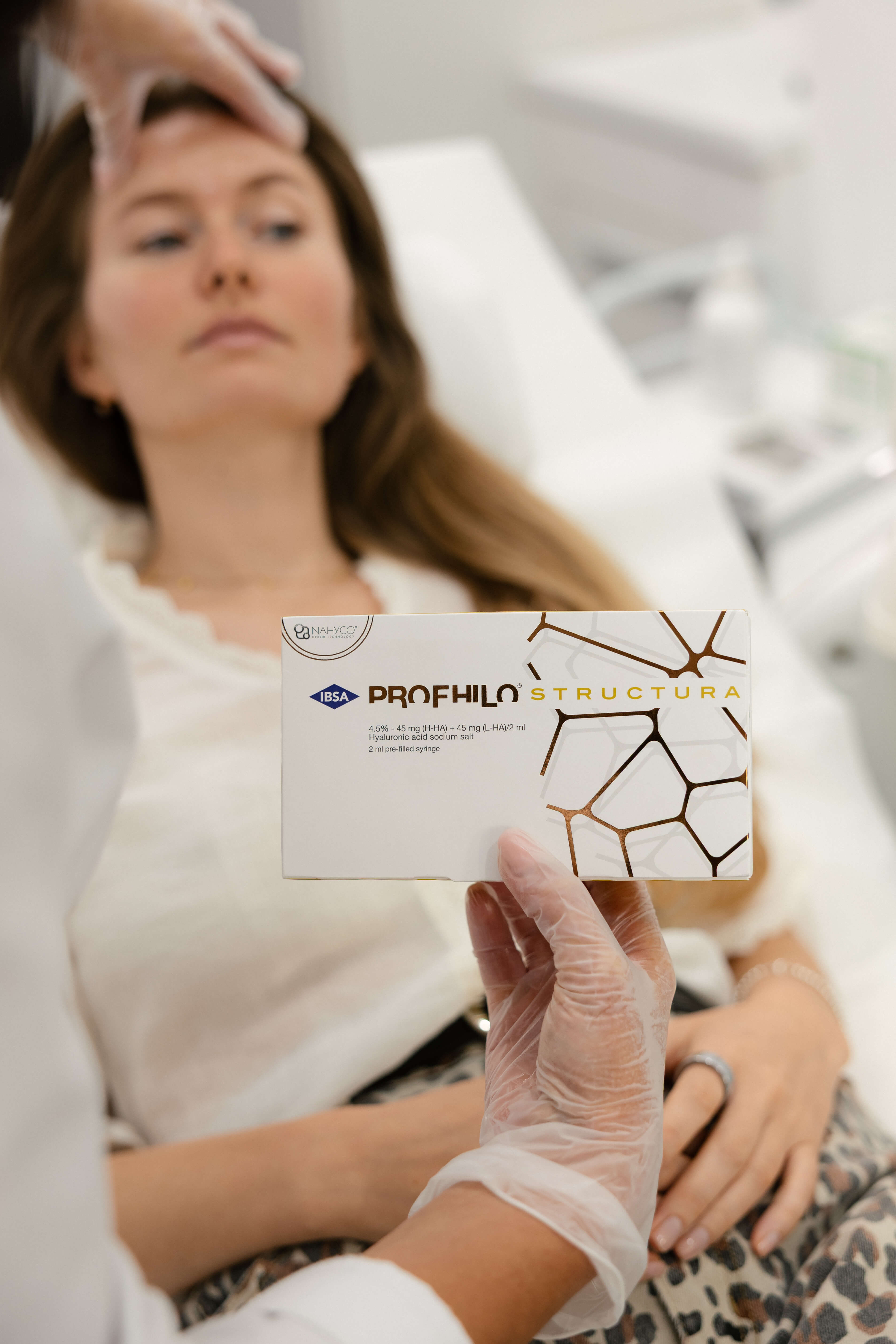 Profhilo Structura aesthetic treatment product presented during a client consultation.