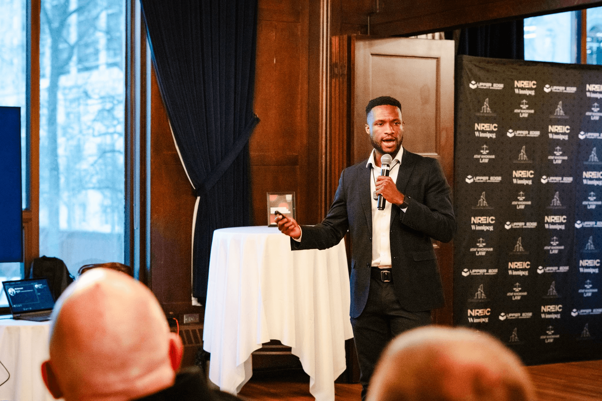 An older, more mature version of David Owasi, giving a presentation about his company, OutreachGenius.
