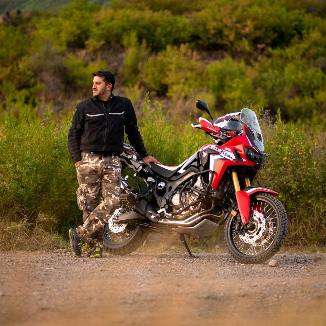 Sanaullah Marwat, co-owner of Coyote Den Hostel, with his motorcycle in Islamabad Pakistan