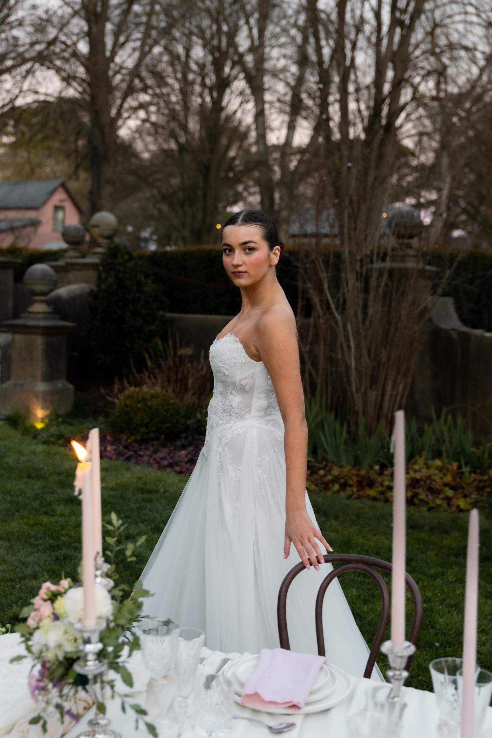 Editorial bridal fashion beside an outdoor reception table at Mona Farm