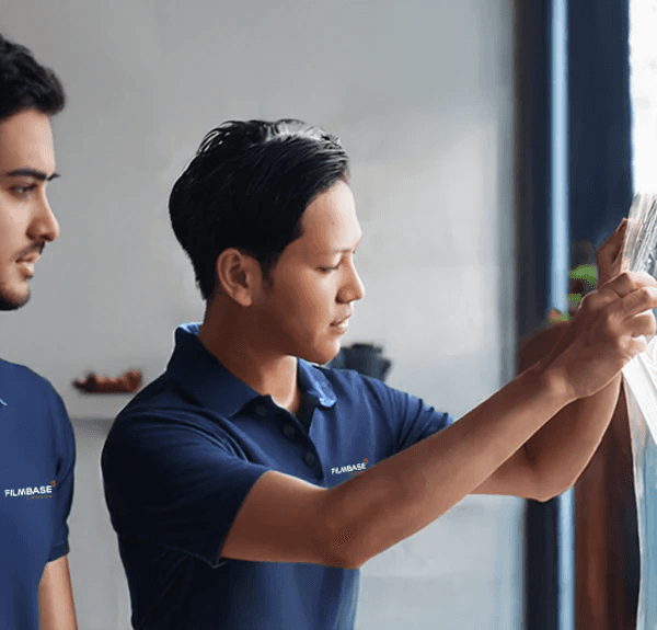 woman sitting around table holding tablet