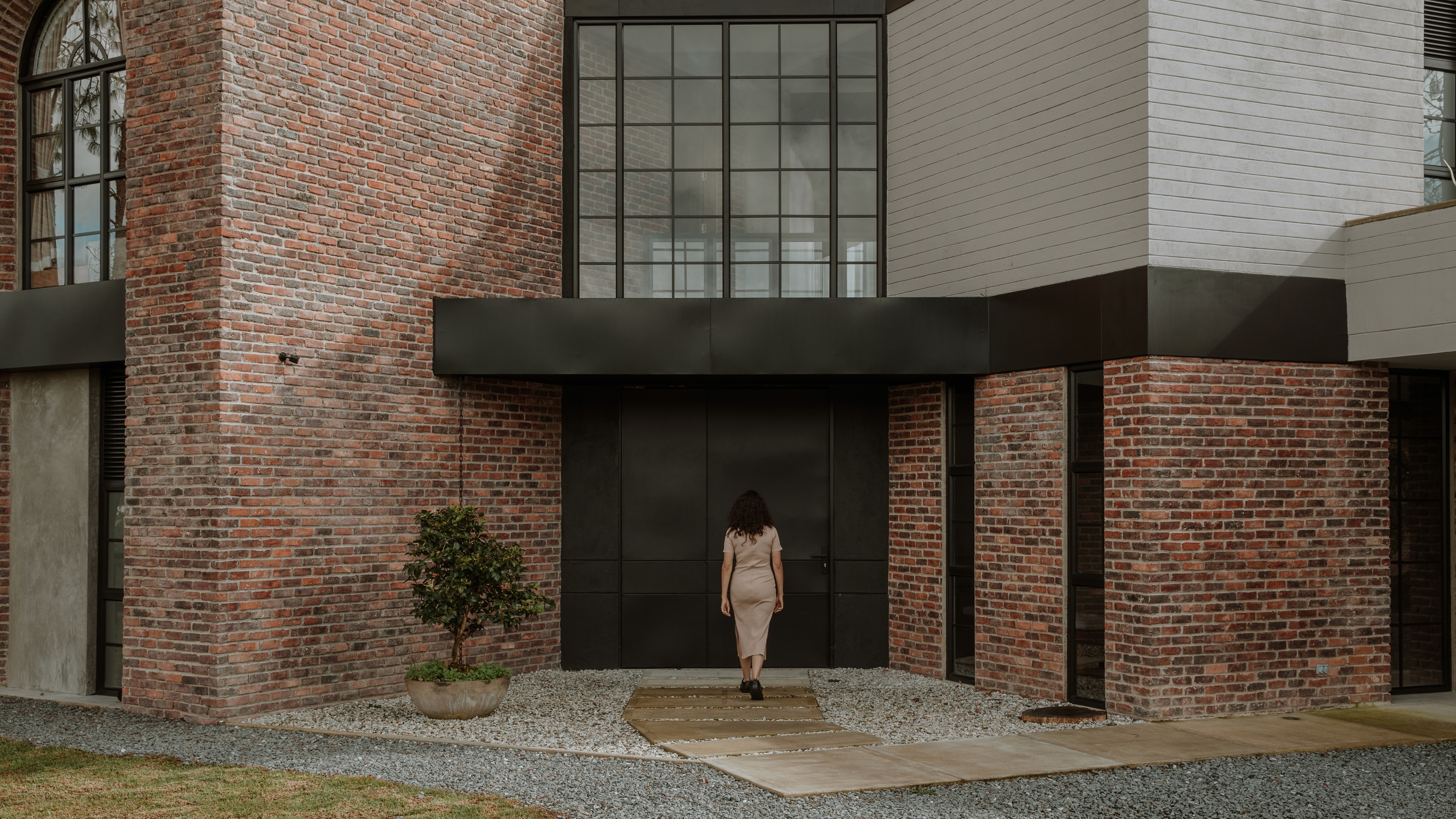 Double-height interior with flowing sculptural forms and warm raking light