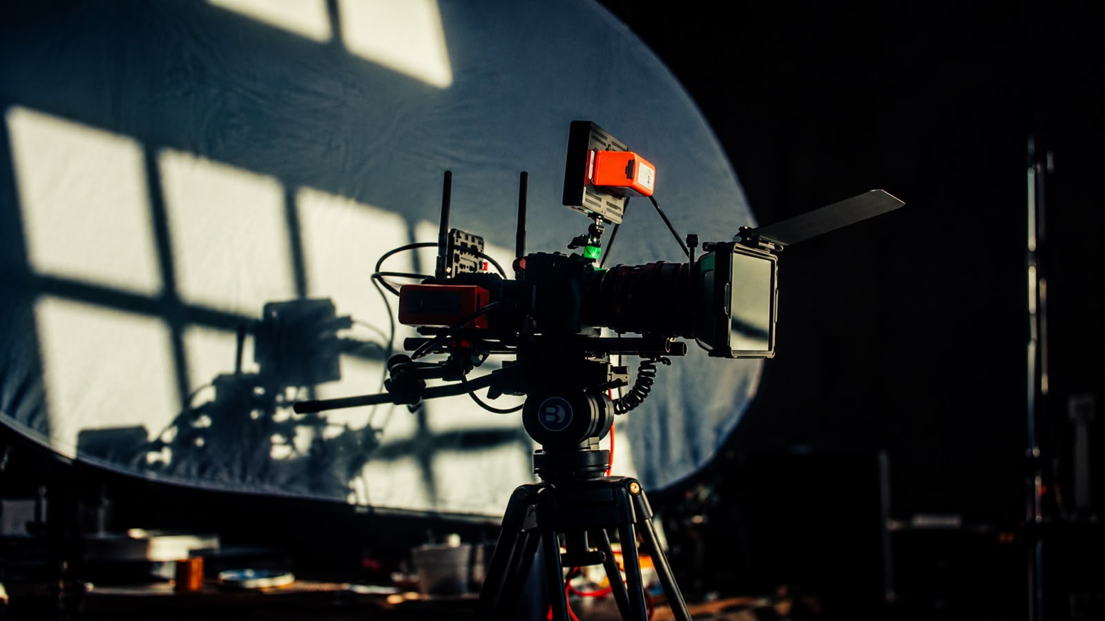a group of people standing around a camera set up