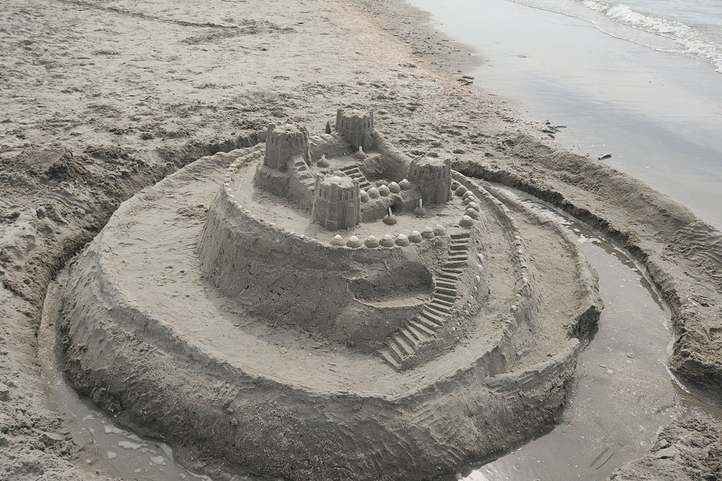 a group of people walking on a sidewalk