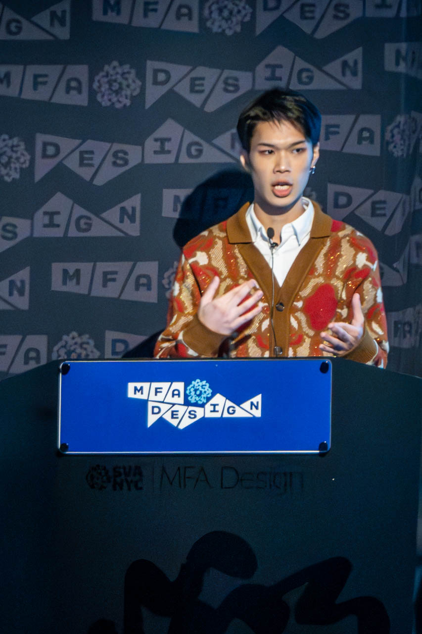 man at a podium delivering a presentation