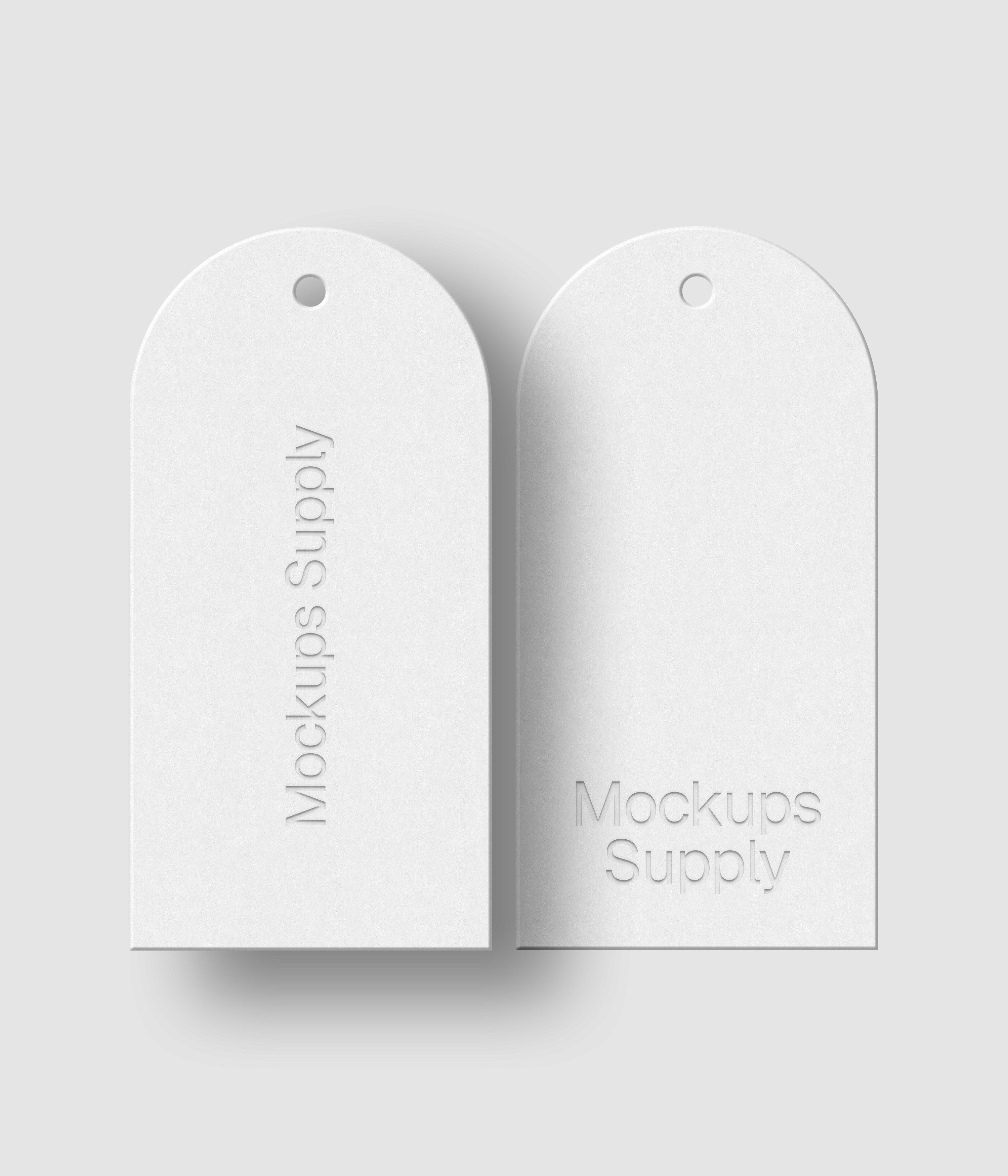 Two white arch hang tags with debossed text effect and editable shadow on white background photoshop PSD mockup template pair
