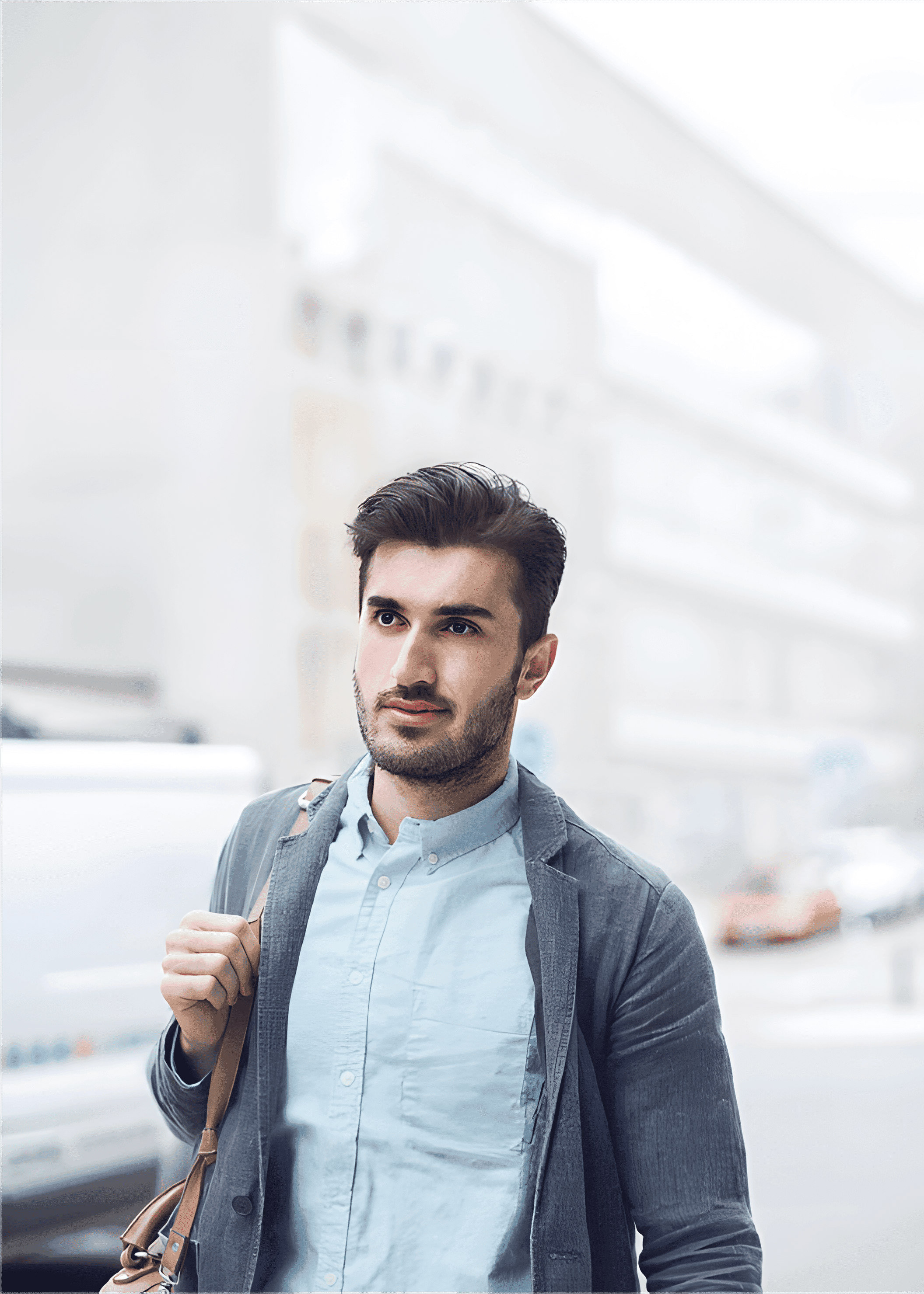 Aerial view of a winding road cutting through rocky terrain and sandy landscape.