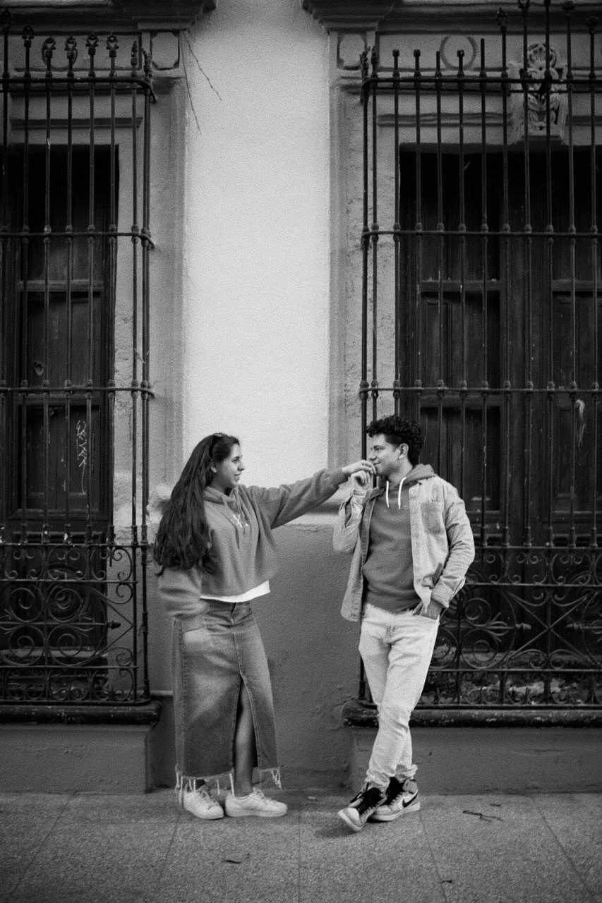 Person stand in front of a red sports oldtimer
