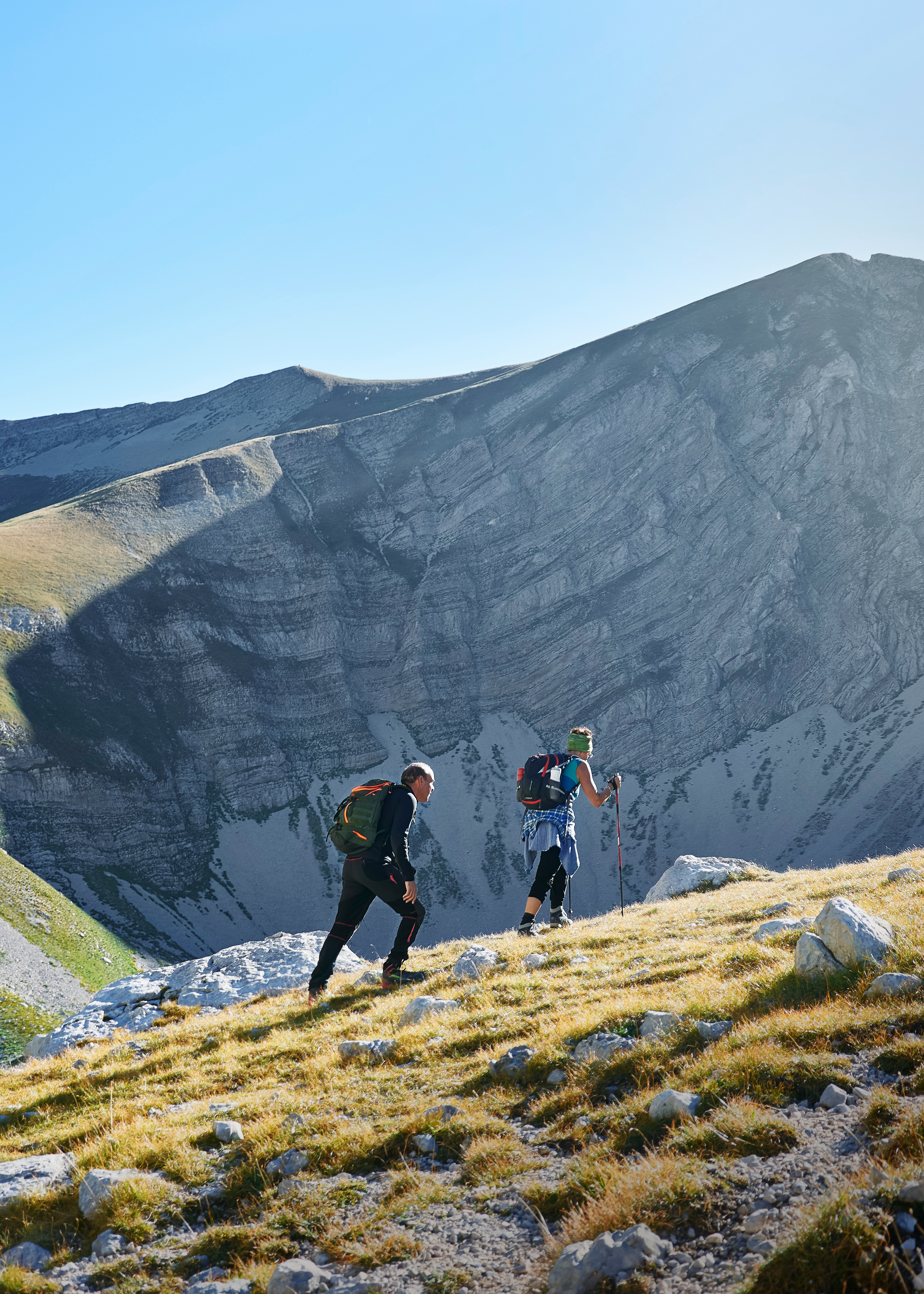 two people walking on mountain