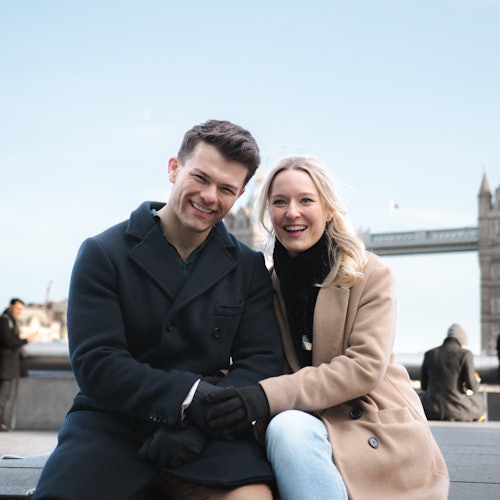 A couple enjoying their photoshoot in front of the iconic Tower Bridge