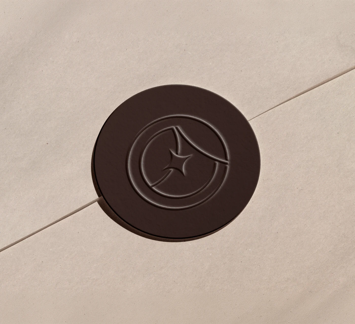Close-up detail of a dark brown circular embossed wax seal stamp with the elegant logo mark.