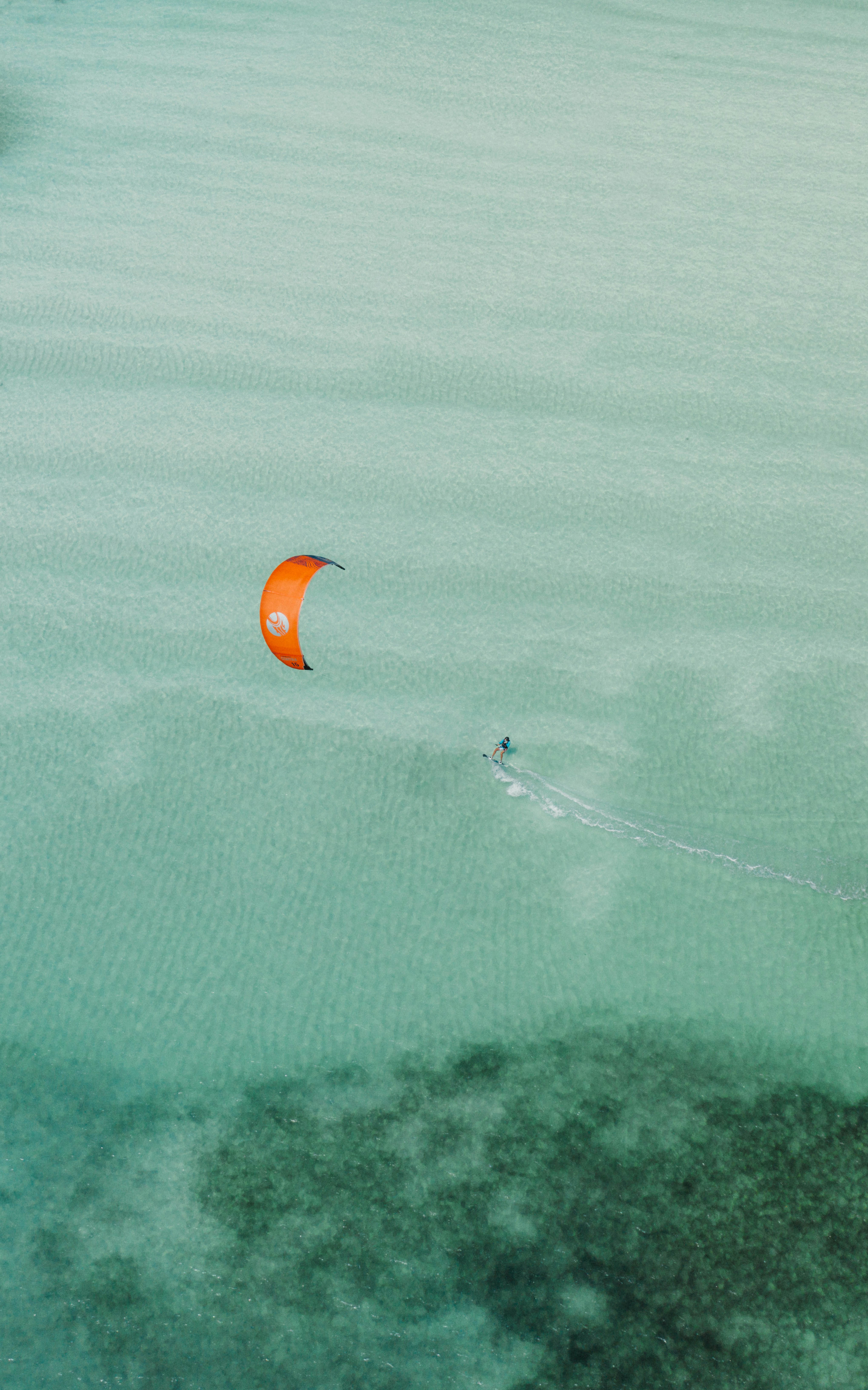 A kitesurfer skimming across the water off Zanzibar's coast
