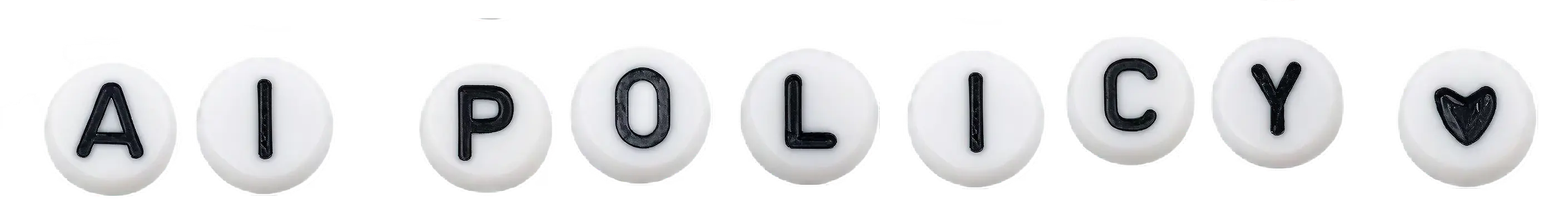 White, round candies each featuring a black letter, spelling the words "WHO WE ARE" with a heart symbol at the end, on a plain background.