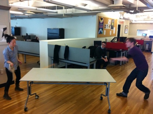 two people playing table-tennis