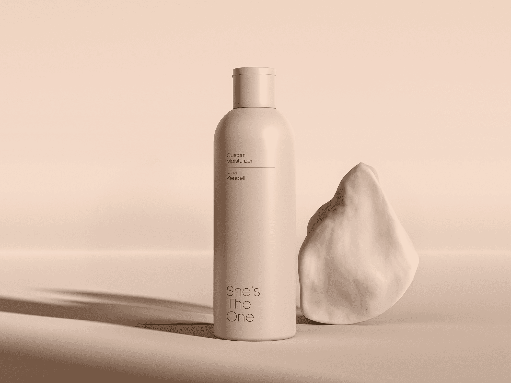 A minimalist product shot featuring a "She's The One" custom moisturizer bottle in a soft satin linen beige. The bottle is positioned next to an organic, cream-colored sculptural stone on a matching beige surface. Fine black typography on the bottle reads "Custom Moisturizer - ONLY FOR Kendell" and the brand logo. Long, soft shadows stretch across the background, creating a serene, high-end architectural feel.