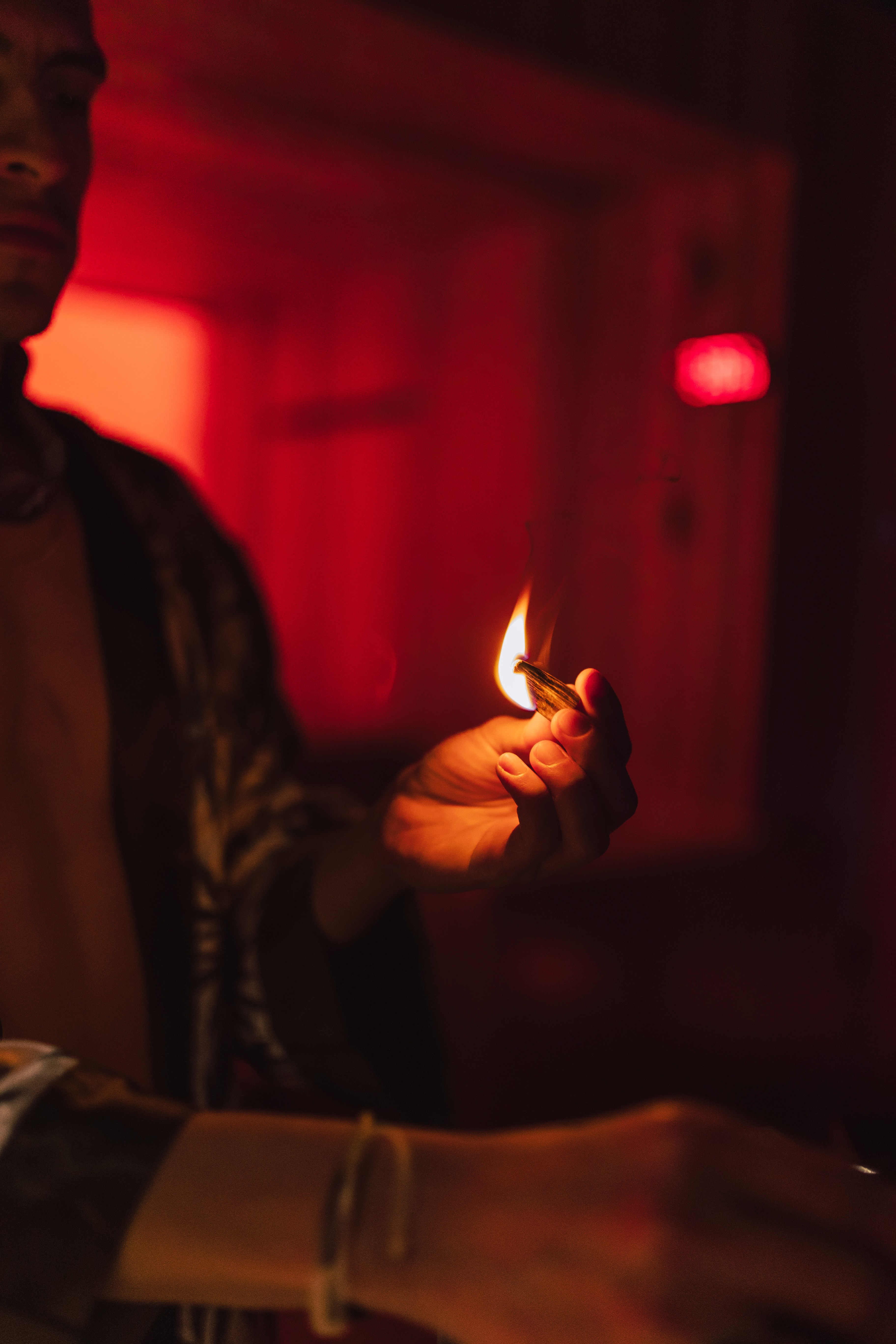 A cozy garden corner featuring potted herbs, a wooden bench, a watering can, and a wicker basket with towels, creating a serene and natural outdoor vibe.