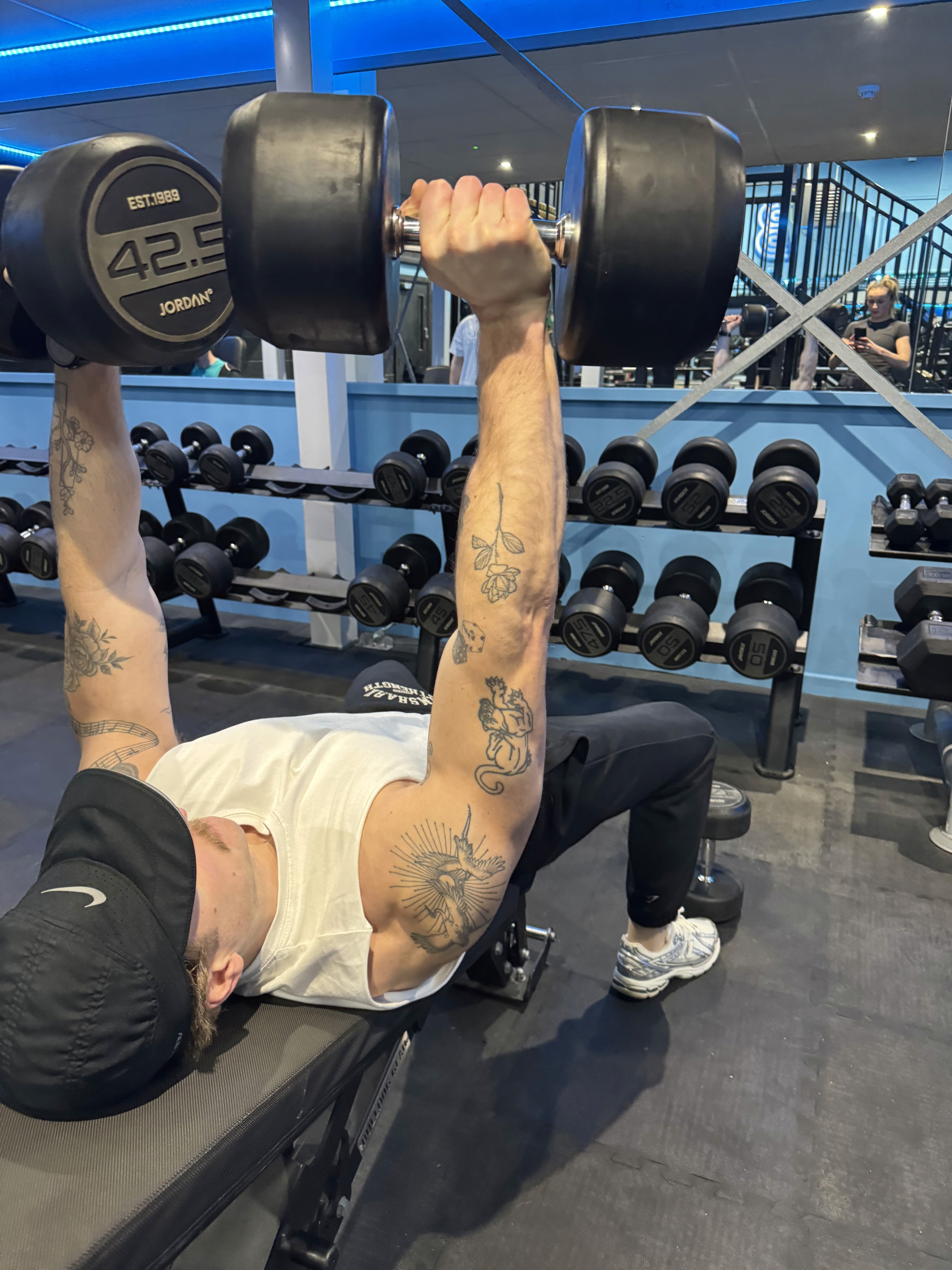 Rachel, personal trainer, looking to the side confidently in a fitness studio