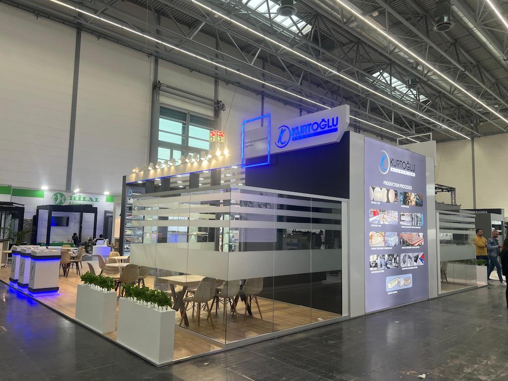 Production process infographic wall at Kurtoğlu's stand, explaining alloying, welding, and highlighting 'Quality and aesthetics together'.