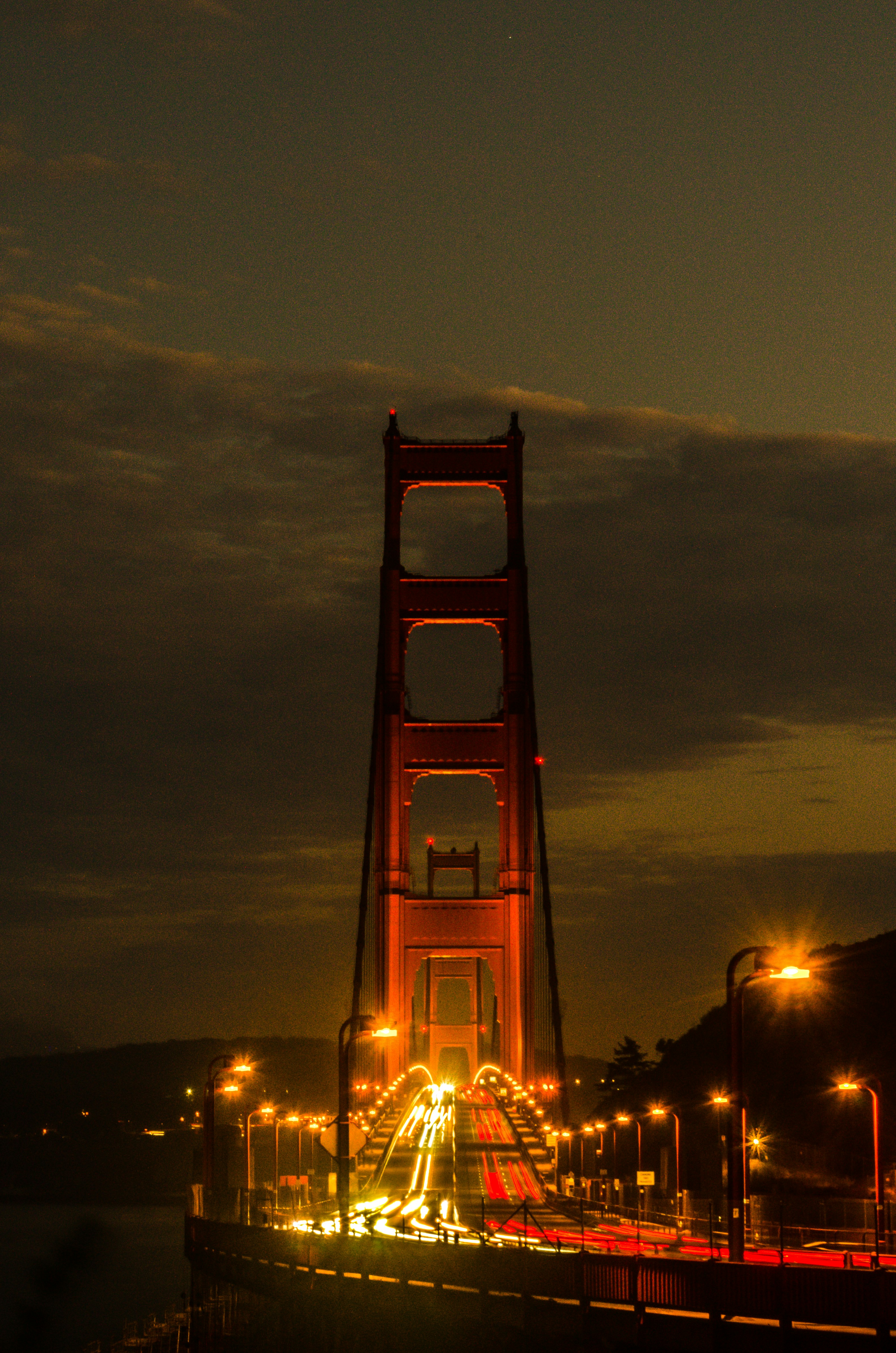 a bridge lit up at night with street lights
