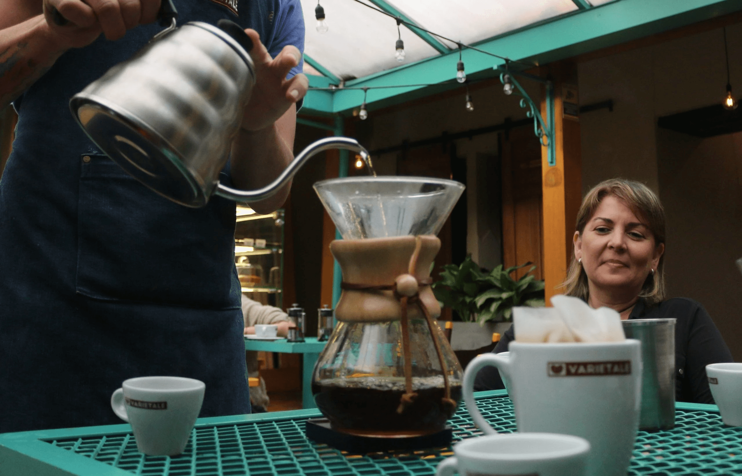 a train traveling over a bridge in the middle of a forest