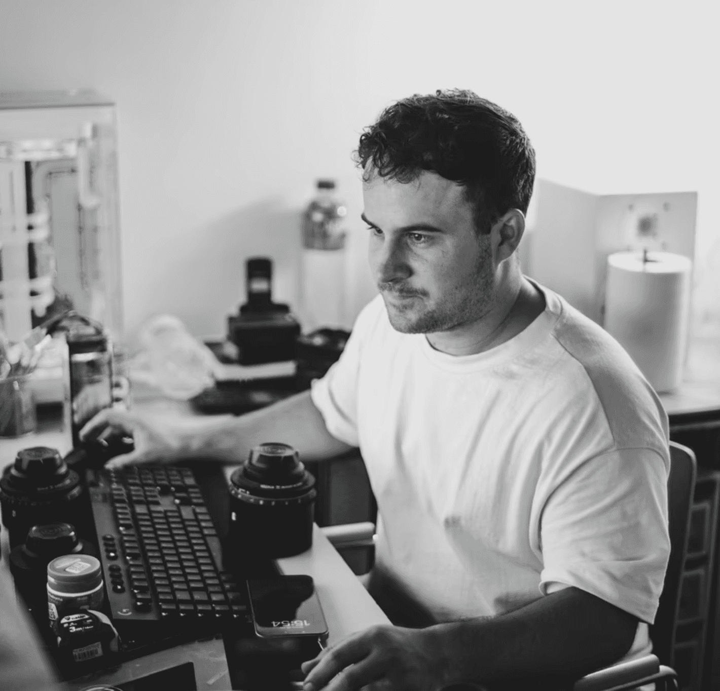 Woman wearing orange-tinted sunglasses and many gold necklaces.