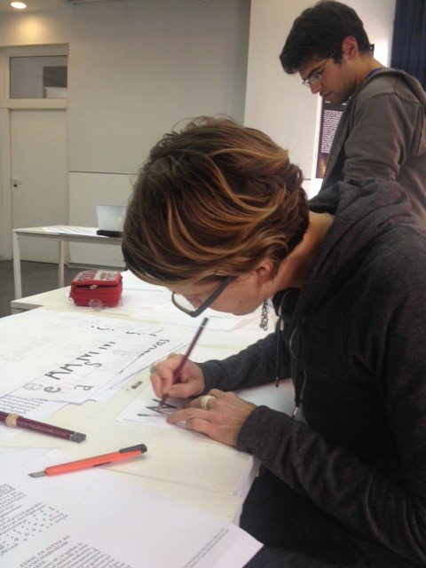 student working on drawing typeface