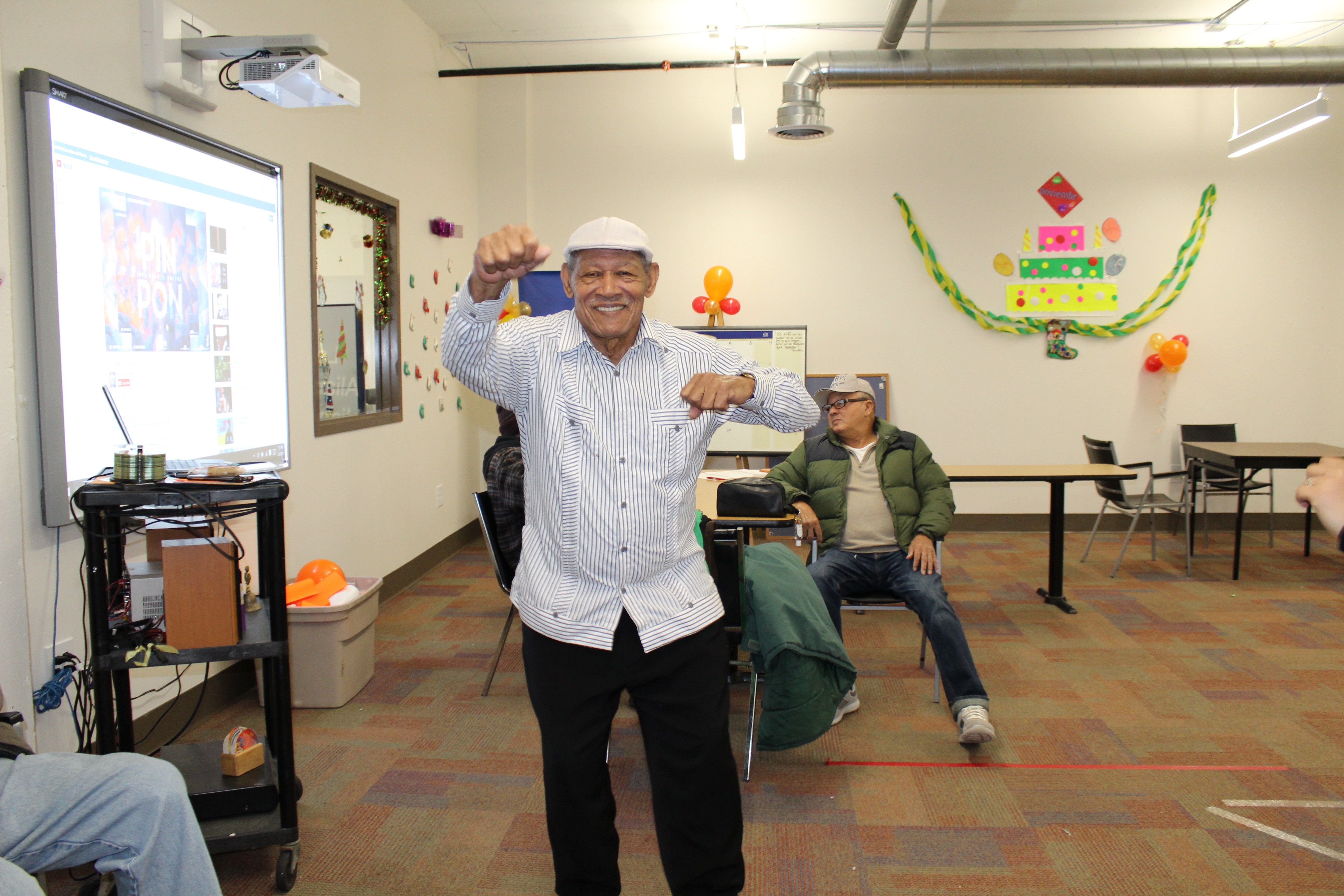 two people in a workspace working on their laptops 