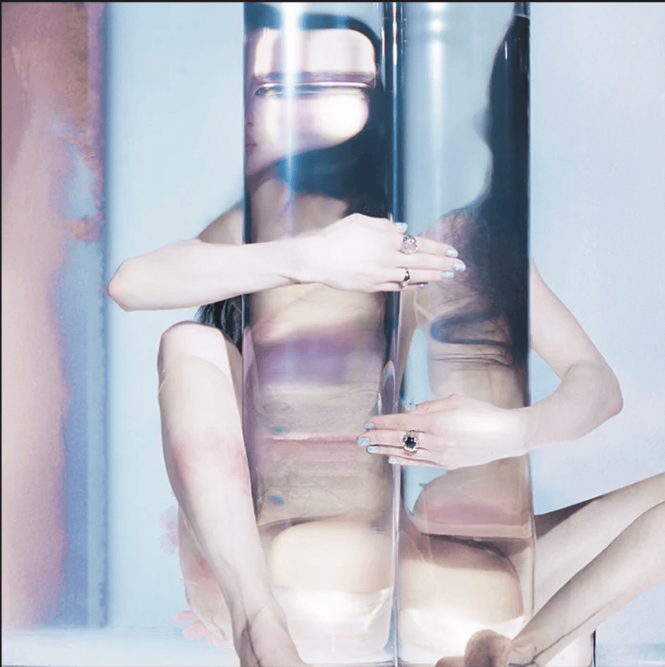 A modern brick house with a two-car garage, well-manicured lawn, and clear blue sky in the background.