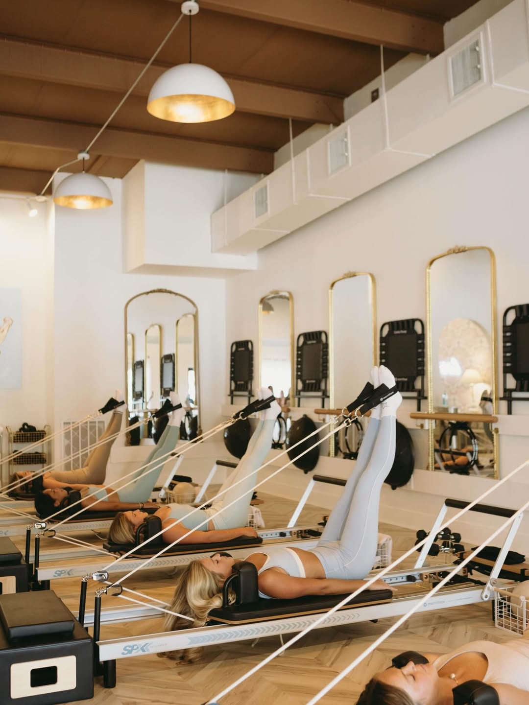 A man runs through a sunlit hallway with striped shadows.