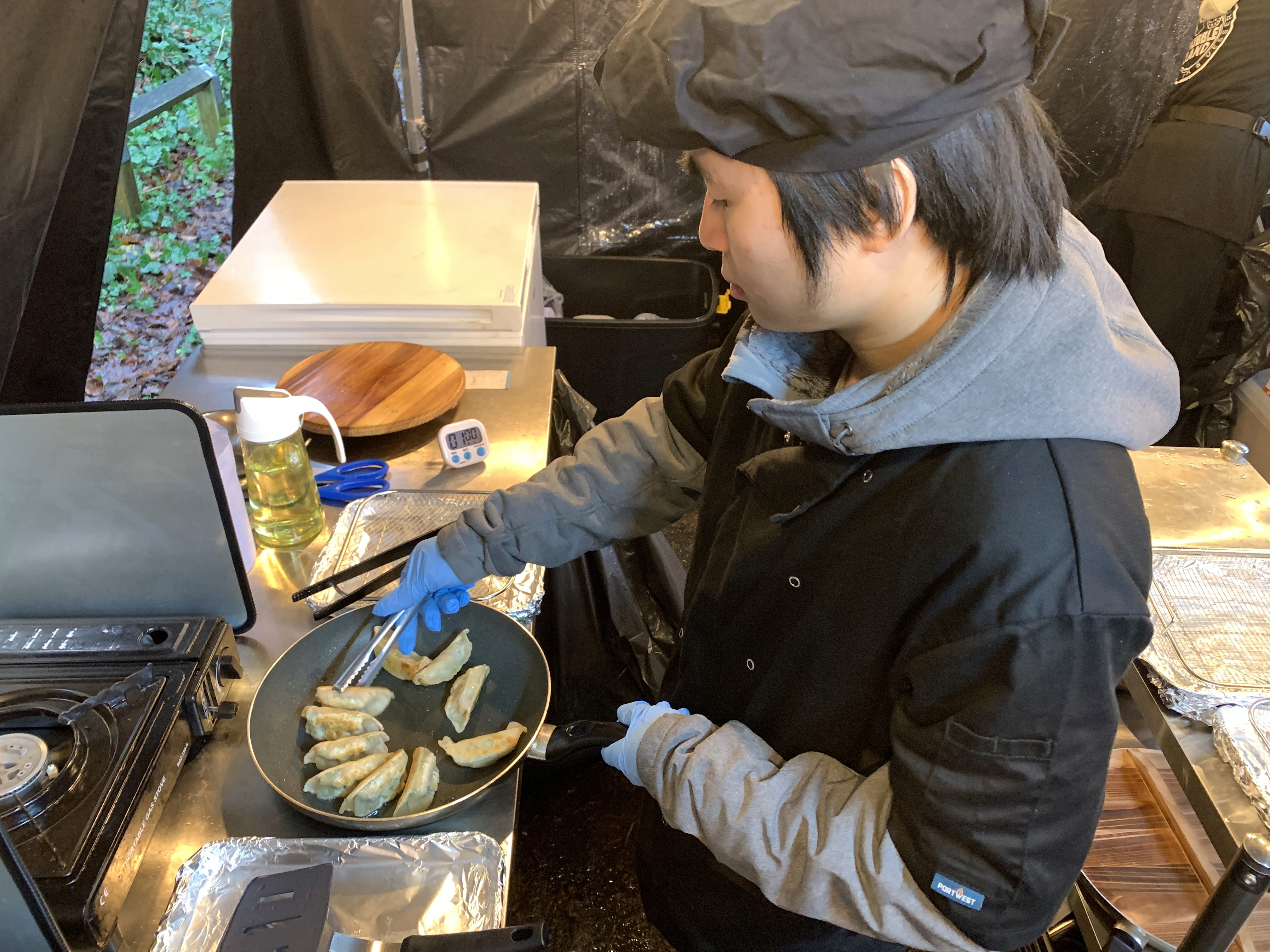 White branded cap with turquoise logo placed on fresh lemons in a red bowl